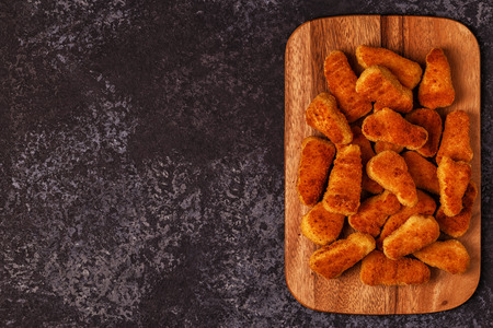 Chicken naggets with sauces on dark background, top view.の写真素材