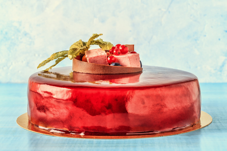 Red Cream Icing Cake with Fruits and Chocolate. Birthday cake.の写真素材