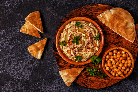 Classic hummus with parsley on the plate and pita bread.の写真素材