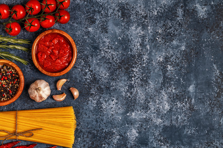 Italian food background with pasta, spices and vegetables. Top view, copy space.の写真素材