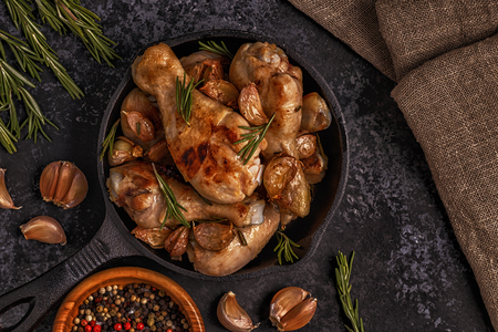 Fried chicken legs with rosemary, garlic and chilli. Top view, copy space.の写真素材