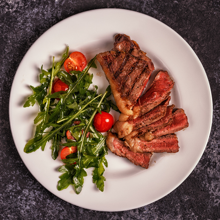 Beef steak on a dark background. Top view, copy space.の写真素材