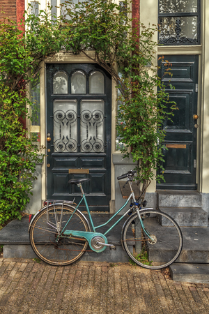 Old Bicycle in front of a House.の写真素材