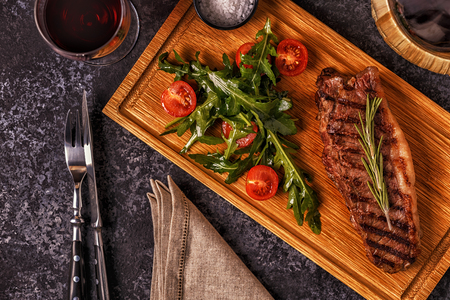 Beef steak on a dark background. Top view, copy space.の写真素材