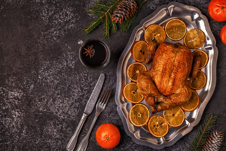 Roasted whole chicken with Christmas decoration. Top view, copy space.の写真素材