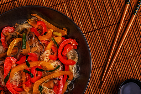 Cooking asian stir fry noodles with vegetables, top view, copy space.の写真素材