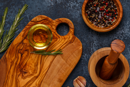 Cutting board and spice for cooking on a dark background.の写真素材