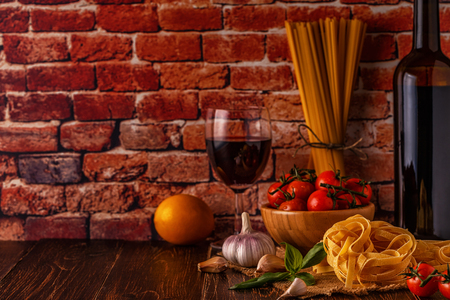 Products for cooking - pasta, tomatoes, garlic, olive oil and red wine. Selective focus.の写真素材