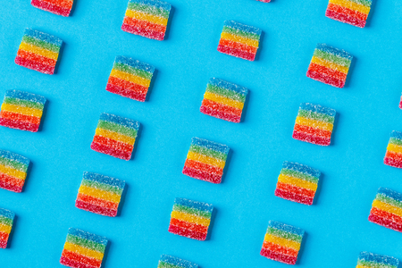 Colorful candies pattern on a blue background. Top view.の写真素材