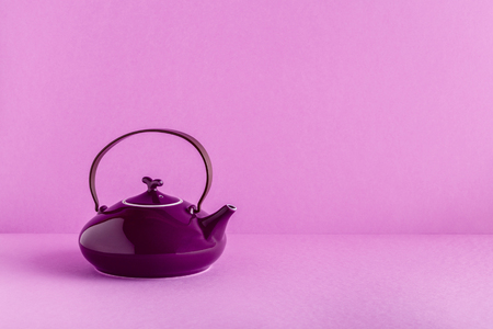 Purple teapot and cups on a lilac background with copy space.の写真素材