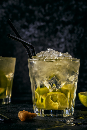 Fresh lime cocktail with ice on dark background.の写真素材