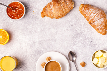 Continental breakfast with fresh croissants, orange juice and coffee, top view.の写真素材