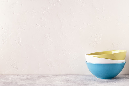 Crockery and cutlery on a light table with copy space.