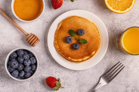 Pancakes with fruit, honey, nuts. Top view.の写真素材