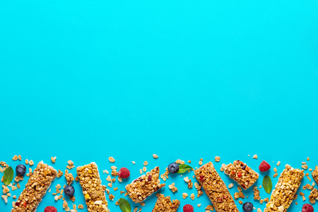 Cereal bars on a bright pastel background, top view.の写真素材