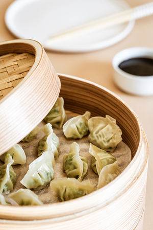 Asian gyoza, dumplings snack, chopsticks, steamer, selective focus.の写真素材