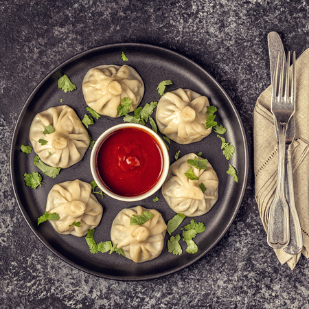 Traditional steamed dumplings Khinkali with Tomato and Tartar sauce, top view.の写真素材
