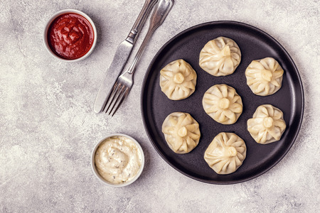 Traditional steamed dumplings Khinkali with Tomato and Tartar sauce, top view.の写真素材