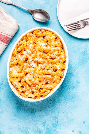 Mac and cheese, pasta baked with cheese sauce, top view.の写真素材