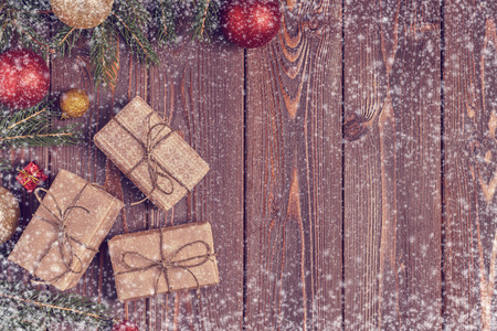 Christmas gift boxes and fir tree  on wooden background. Top view with copy spaceの写真素材