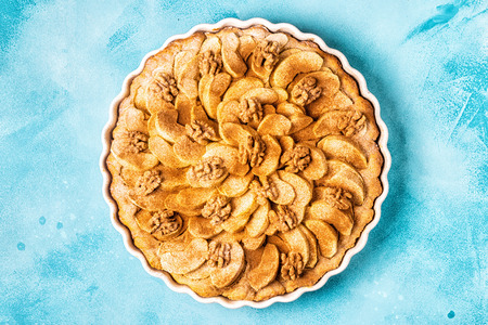 Apple pie with walnuts and cinnamon, top view.の写真素材
