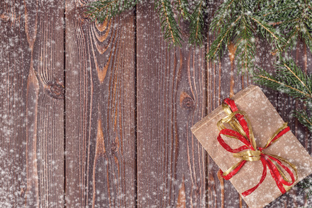 Christmas gift boxes and fir tree  on wooden background. Top view with copy spaceの写真素材