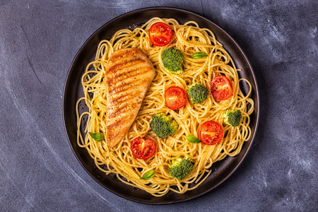 Plate of spaghetti tomato broccoli chicken,  concept of  healthy diet foodの写真素材