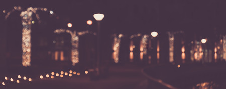 Blurred abstract urban background, bokeh of city lights, vintage or retro color tone.