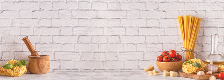 Products for cooking - pasta, tomatoes, garlic, olive oil, basil. Copy spase.の写真素材