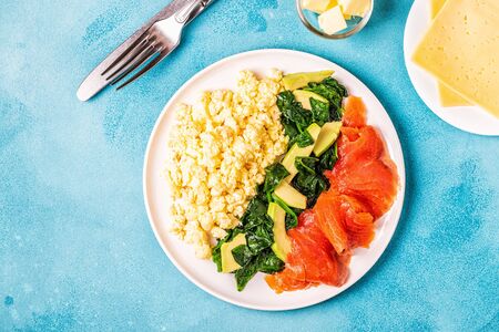 Ketogenic diet breakfast, scrambled eggs, salmon, avocado, spinach, top view.の写真素材
