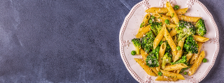 Pasta with broccoli, green peas, garlic, cheese, top view.の写真素材