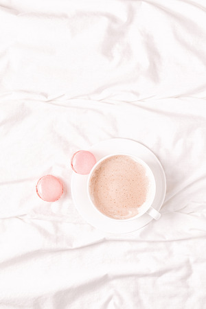 Bed with coffee and macaroons, top view, copy space, flat lay.の写真素材