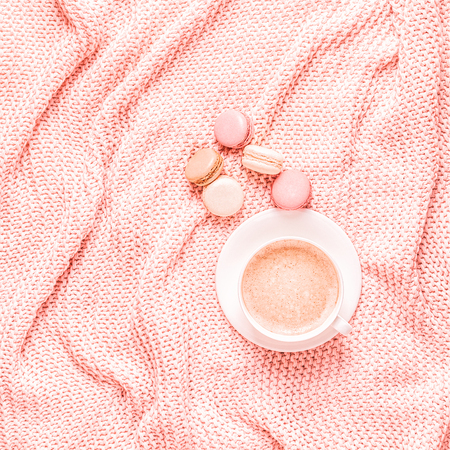 Background with pink plaid, coffee and macaroons, top view, copy space, flat lay.の写真素材