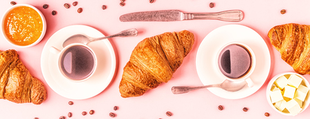 Coffee and croissants on pastel background, top view.の写真素材