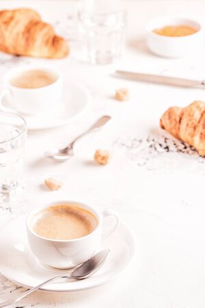 Traditional breakfast with fresh croissants on white background, vertical.の写真素材