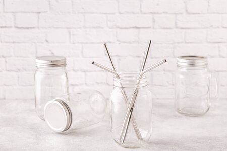 Reusable metal drinking sraws and cleaning brush in a jar. Zero waste concept.の写真素材
