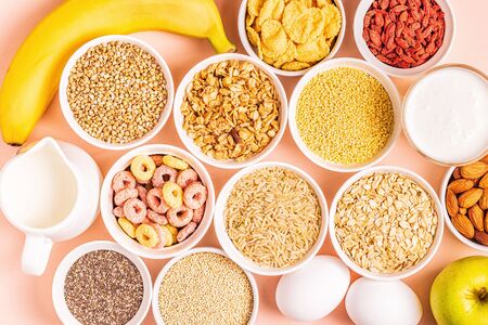 Ingredients for healthy breakfast - cereals, grains, dairy products, seeds, nuts and fruits.の写真素材