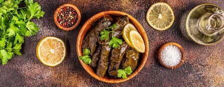 Dolma, stuffed grape leaves with rice and meat on dark background, top view.の写真素材