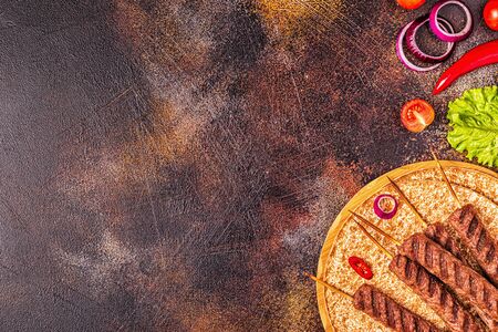 Traditional middle eastern, arabic or mediterranean meat kebab with vegetables and lavash bread. Top view.の写真素材