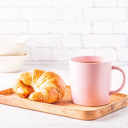 French croissants and cup of coffee  on a wooden tray.の写真素材