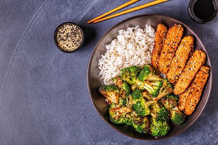 Fried tempeh with rice and broccoli, traditional indonesian cuisine.の写真素材