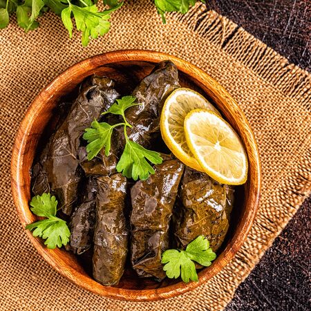 Dolma, stuffed grape leaves with rice and meat on dark background, top view.の写真素材