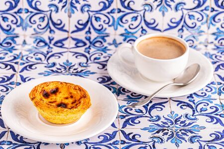 Egg tart, traditional Portuguese dessert, pastel de nata. Azulejo tile background.