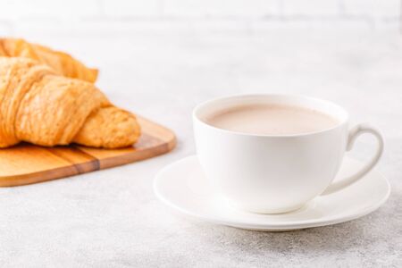 Breakfast with coffee and croissants, selective focus
