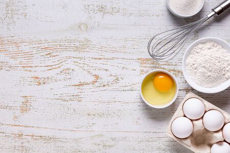Ingredients for baking  - flour, eggs, salt, sugar, milk. Top view, copy space.