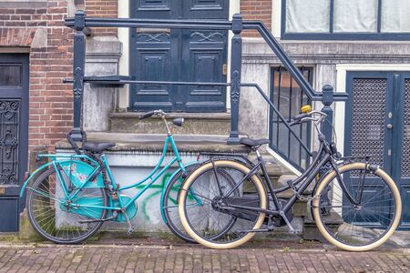 Old Bicycles in front of a House.の写真素材