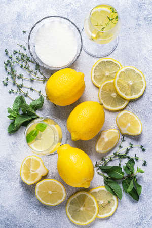 Ingredients for refreshing lemonade - lemons, mint, thyme, sugar, top view.の写真素材