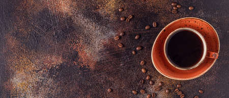 Coffee and croissant on stone background. French breakfast. Top view with copy space.