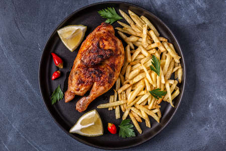Half roasted chicken Piri Piri with french fries, top viewの写真素材