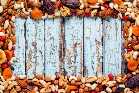 Frame made of various nuts and dried fruits, copy space.